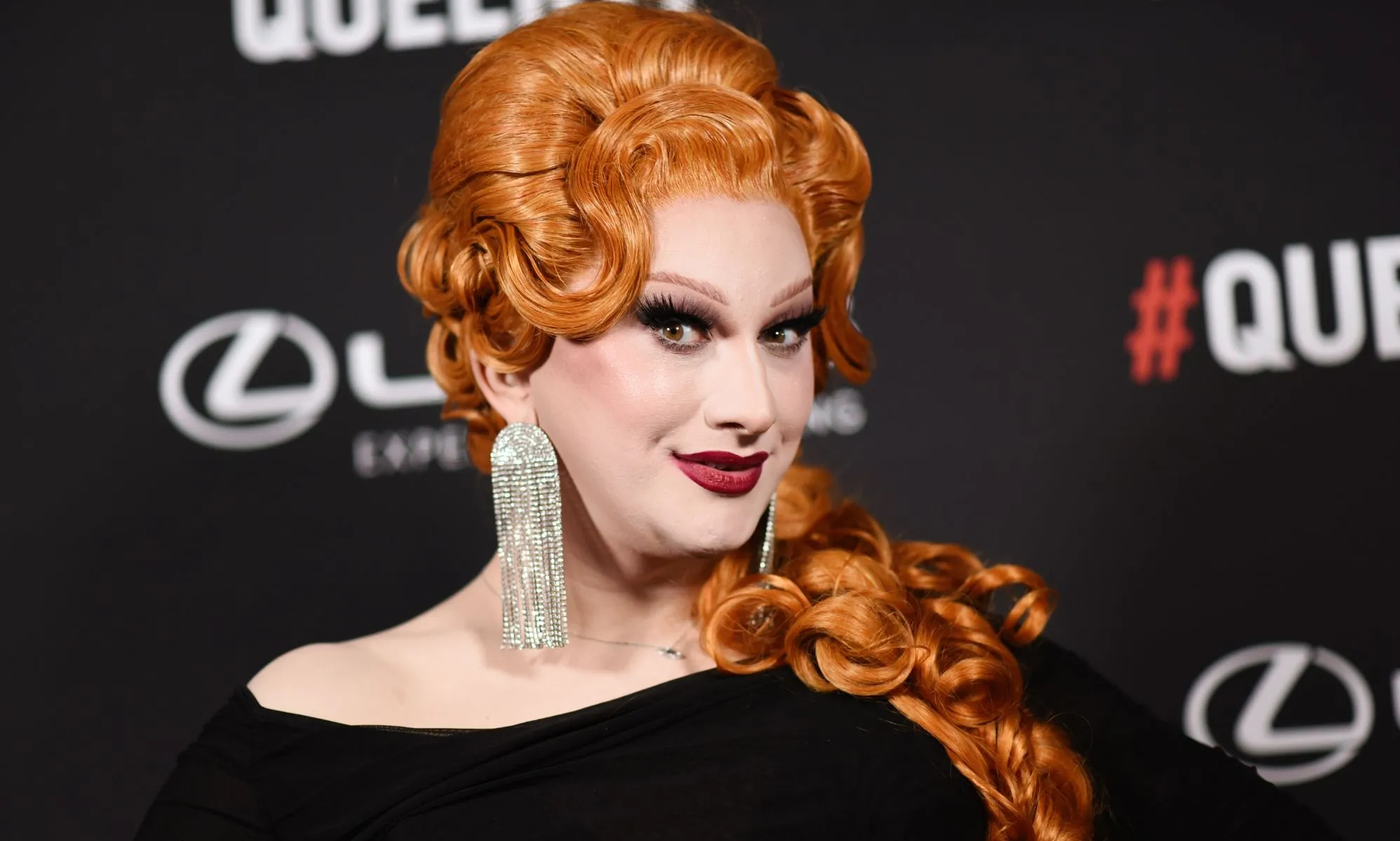 RuPaul's Drag Race winner Jinkx Monsoon in a ginger wig and black dress at the 2024 Queerty awards.