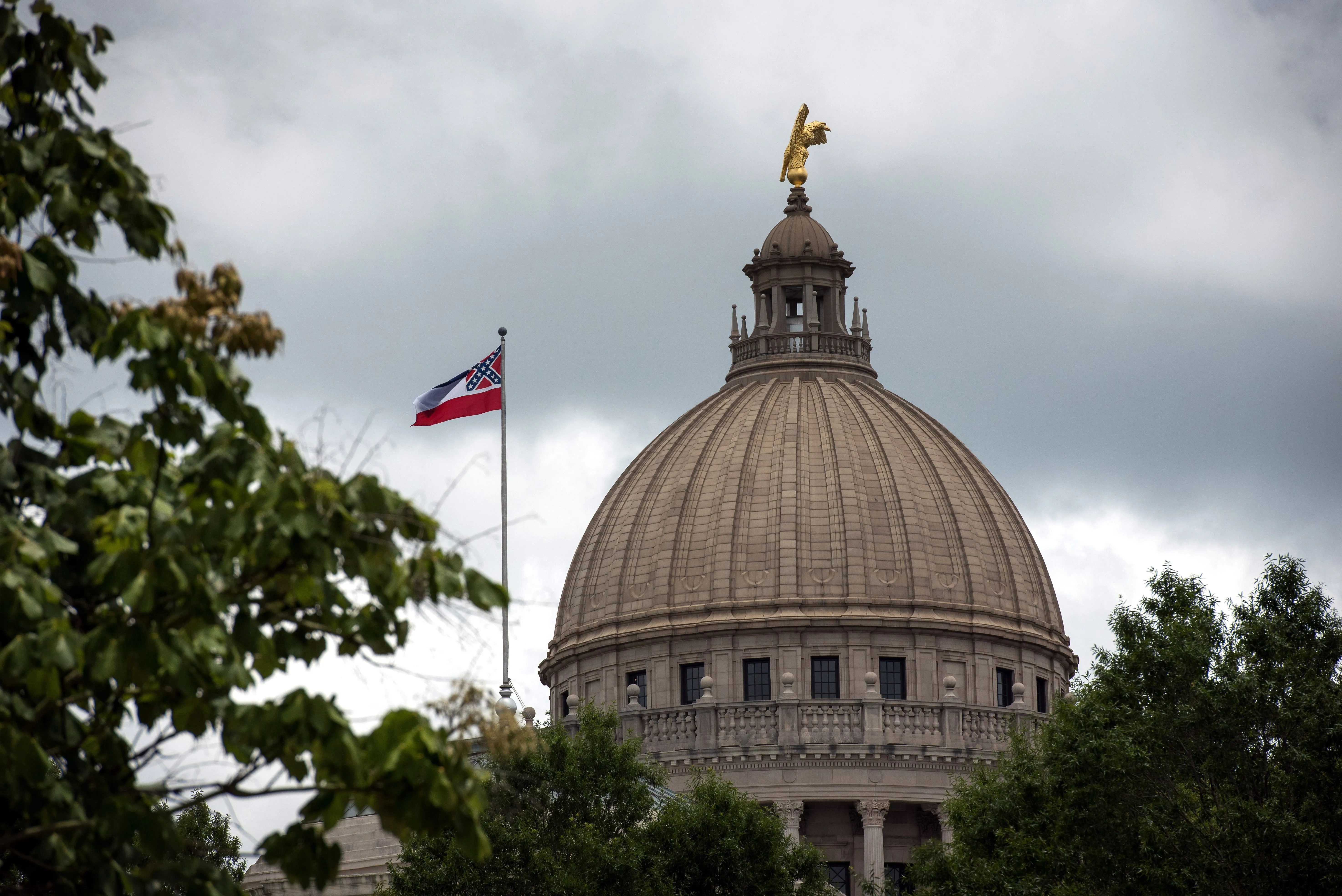 The state flag flies over the Mississippi State Capitol building in Jackson, Mississippi on June 29, 2020.